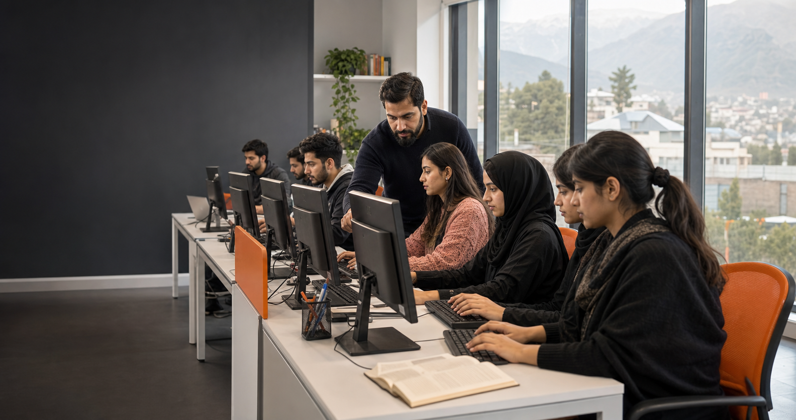 Students learning computer skills with an instructor in a modern training classroom